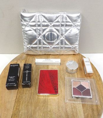a table with a purse, lipstick, and other items on it