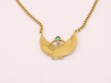 a gold necklace and earring set with a green stone