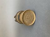 a gold knob on the wall of a bathroom