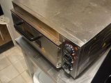 a toaster oven sitting on top of a counter in a kitchen