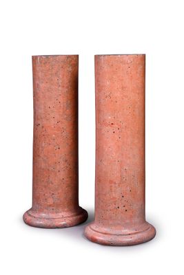 two red vases sitting next to each other on a white surface