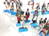 many figurines of soldiers on display in a display case