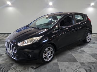 the black ford fiesta is parked on a checkered tile floor
