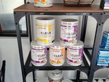 many cans of paint on a shelf in a store