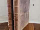 two books that are sitting on a wooden table