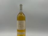une bouteille de vin blanc vide posée sur une table blanche