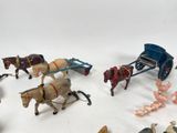 a lot of small toy figurines of horses and carriages