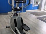 an image of a gym room with a tread machine and a blue wall
