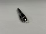 a close up of a pen on a table with a white background