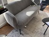 a couch that is sitting on a rug in a living room