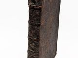 un vieux livre posé sur une surface blanche