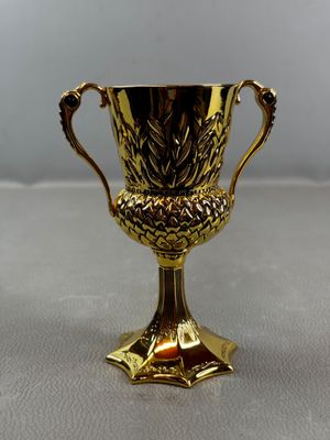 an image of a gold trophy sitting on top of a table