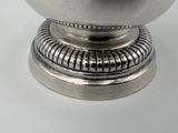 a silver bowl sitting on top of a metal stand
