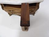 a marble sink with a wooden handle on it
