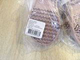 two pairs of pink slippers that are wrapped in plastic