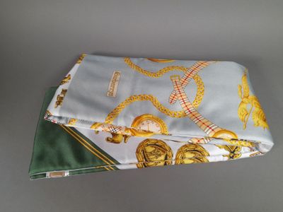 a folded handkerchief with a gold and green design on it