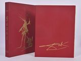 two red books with gold writing on them sitting on a white surface