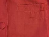 a close up of a red shirt with buttons on the chest