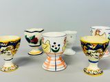 five different types of painted egg cups on a table