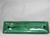 an old green tray with holes in it sitting on a table
