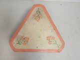 a triangle shaped object with flowers painted on it