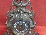 a clock that is sitting on a red cloth
