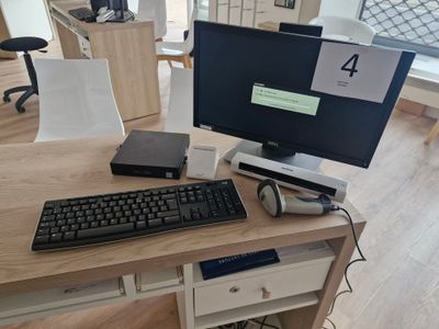 a desk with a keyboard, mouse and monitor on it