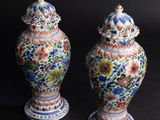 pair of chinese vases on a black background with a black background