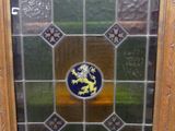 an old stained glass window with a lion in the center