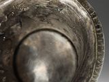 a close up of a metal object on a white surface