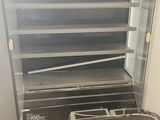 an open oven that is sitting on the floor