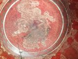 a glass bowl with a red and white design on it