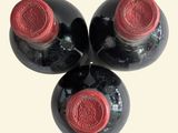 three bottles of wine sitting next to each other on a table
