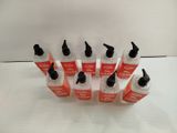 six bottles of liquid sitting on top of a white surface