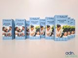 four boxes of baby powder sitting on top of a table