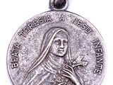 a silver medal with the image of a woman holding a star