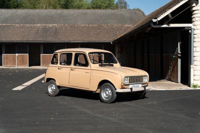 a small tan car parked in front of a building