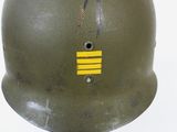 a green helmet with a yellow stripe on it