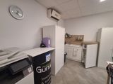 an image of a kitchen with white appliances and a clock on the wall