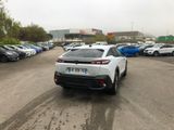 a white car parked in a parking lot next to other cars