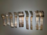 a lot of forks that are lined up on a table