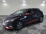 a black and red nissan micna parked in a garage