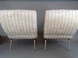 pair of mid - century modern lounge chairs in the style of miloni