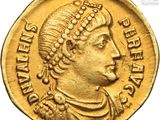 a gold coin with an image of a man wearing a headdress