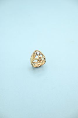 a close up of a gold ring on a white surface