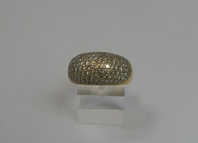 a gold and diamond ring on a clear acrylic stand