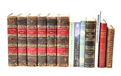 a lot of books that are stacked on top of each other