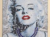 painting of a woman with blue eyes and a necklace in a frame