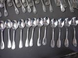 a lot of silver spoons and spoon spoons on a table