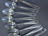 a lot of silver spoons and forks on the table